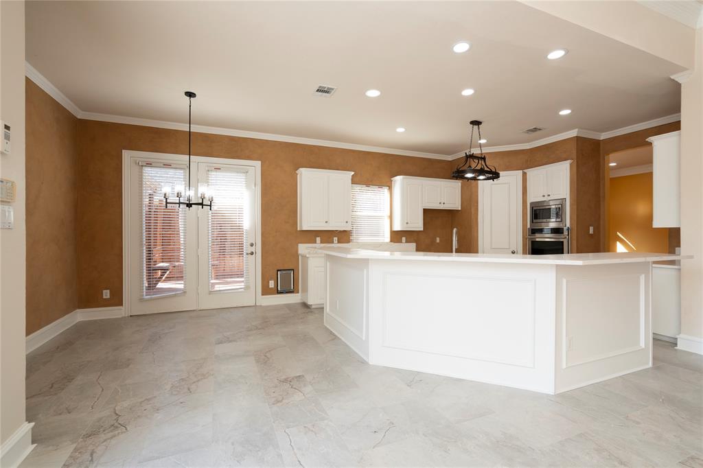 1425 Kingsmill Court Coppell, TX 75019 - Photo 17 of 30 a large white kitchen with a large window