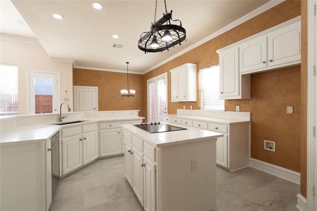 1425 Kingsmill Court Coppell, TX 75019 - Photo 21 of 30 a kitchen with a sink dishwasher a stove a microwave oven and a refrigerator with wooden floor
