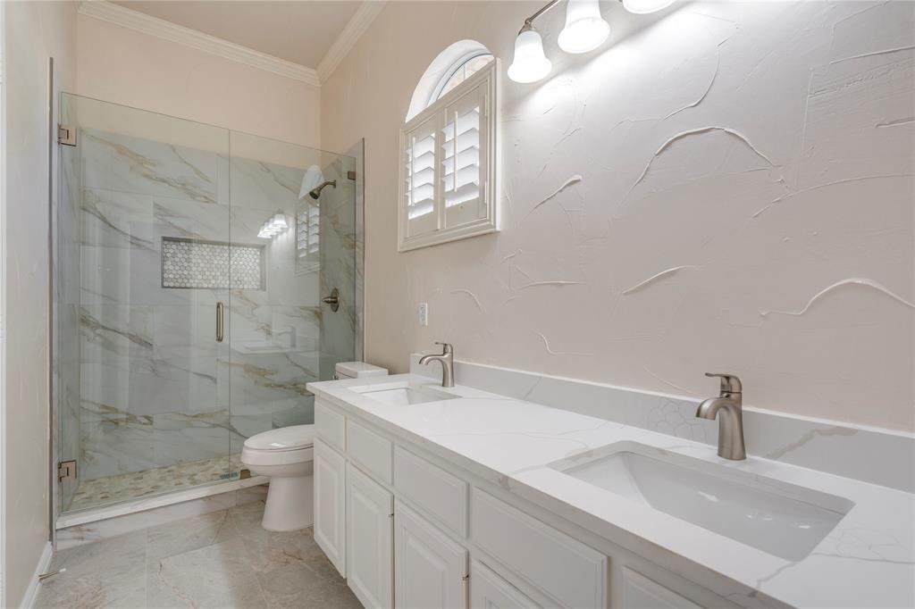 1425 Kingsmill Court Coppell, TX 75019 - Photo 29 of 30 a bathroom with a double vanity sink mirror and shower