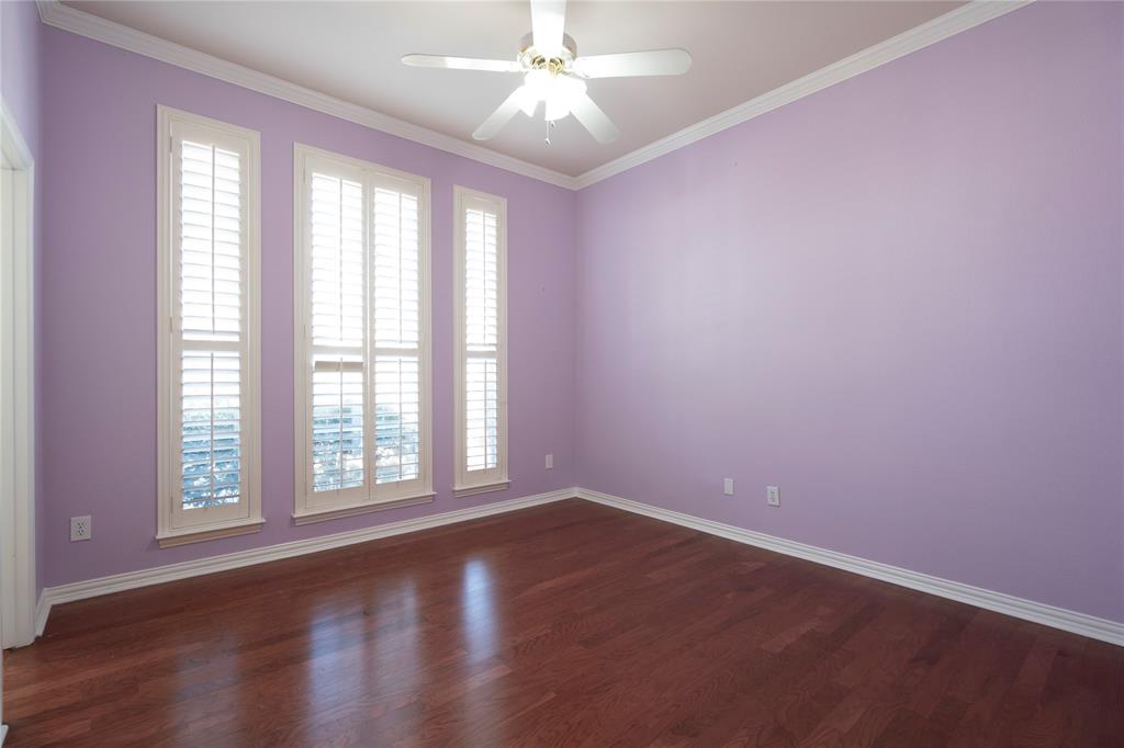 1425 Kingsmill Court Coppell, TX 75019 - Photo 4 of 30 an empty room with wooden floor and windows