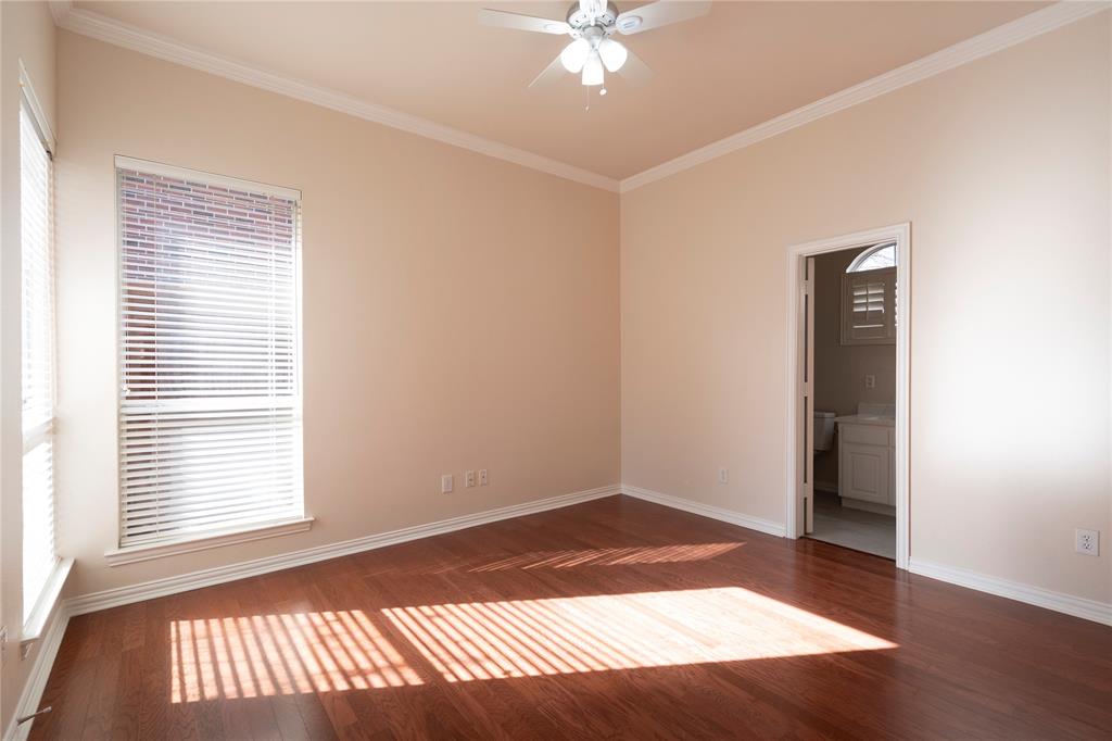1425 Kingsmill Court Coppell, TX 75019 - Photo 5 of 30 an empty room with wooden floor and windows