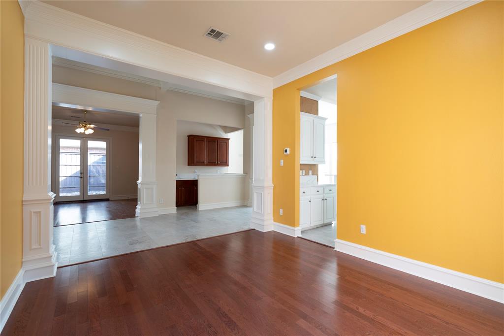 1425 Kingsmill Court Coppell, TX 75019 - Photo 8 of 30 an empty room with wooden floor and windows