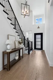 a view of entryway and hall with wooden floor