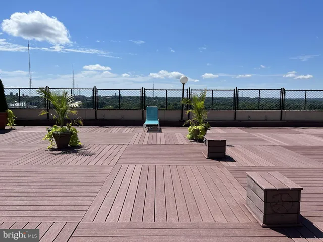 a view of a room with a kitchen and wooden floor