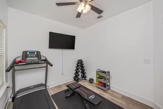 512 Vale Loop Crestview, FL 32536 - Photo 48 of 83 a room with gym equipment and a flat screen tv