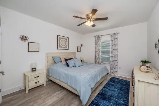 512 Vale Loop Crestview, FL 32536 - Photo 58 of 83 a bedroom with a bed and a chandelier