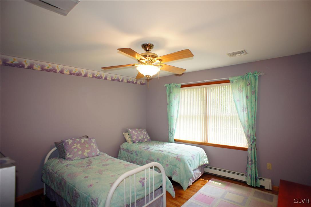 106 Stender Road Stroudsburg, PA 18360 - Photo 29 of 47 a bedroom with two beds and a chandelier