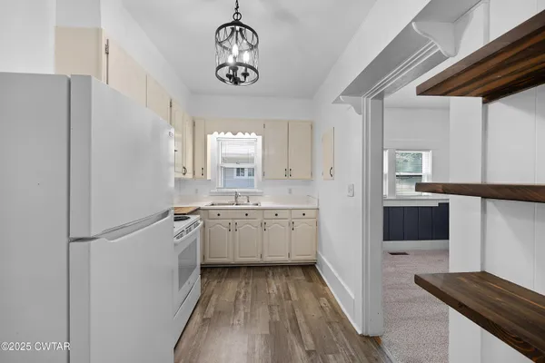 a kitchen with a refrigerator and a sink