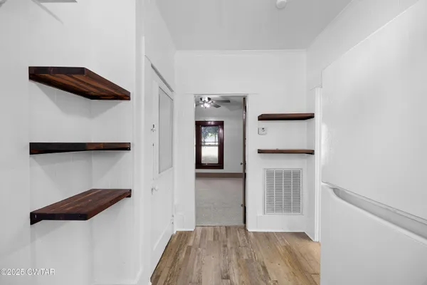 a hallway view with staircase