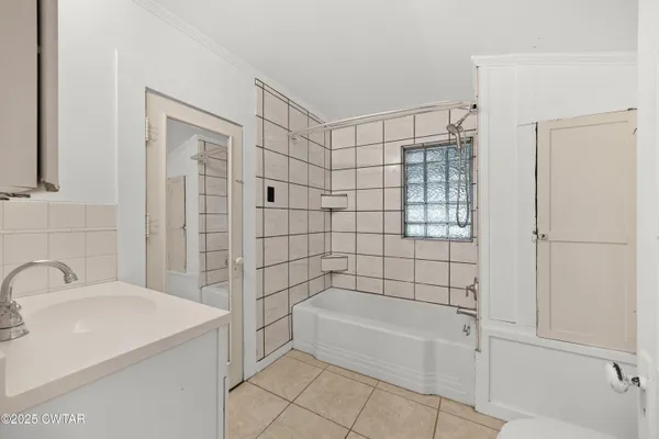 a bathroom with a bathtub shower sink and toilet