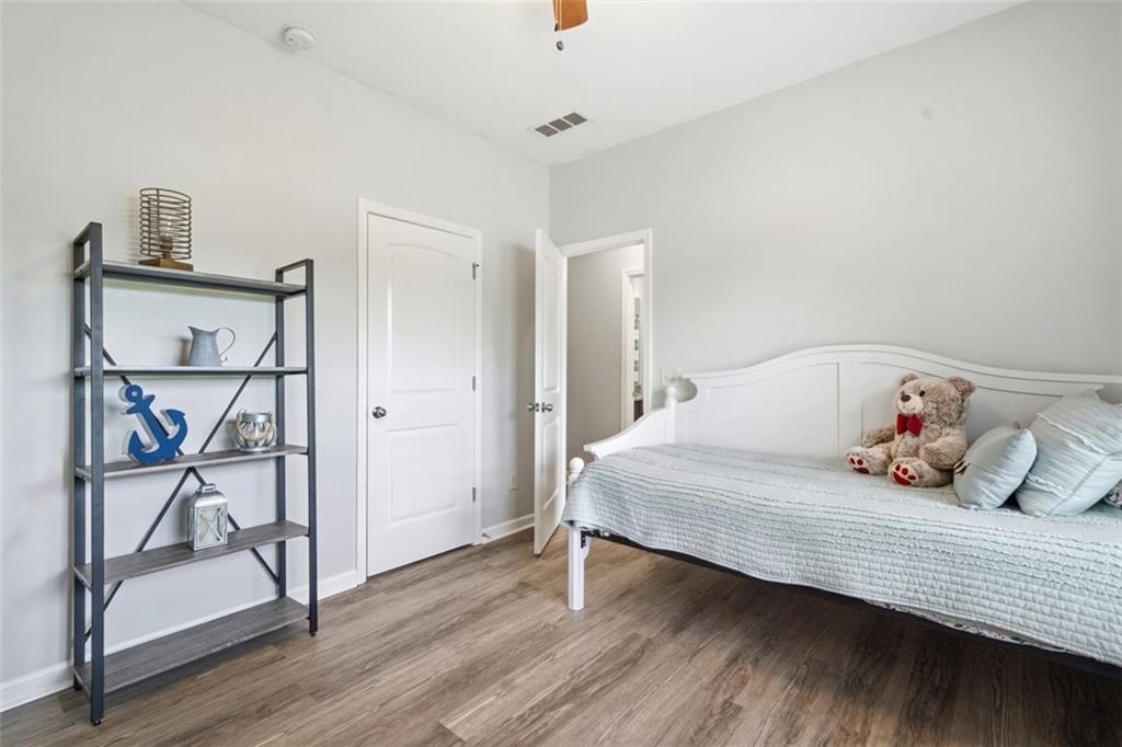 302 Spence Circle Ball Ground, GA 30107 - Photo 33 of 55 a bedroom with a bed and wooden floor