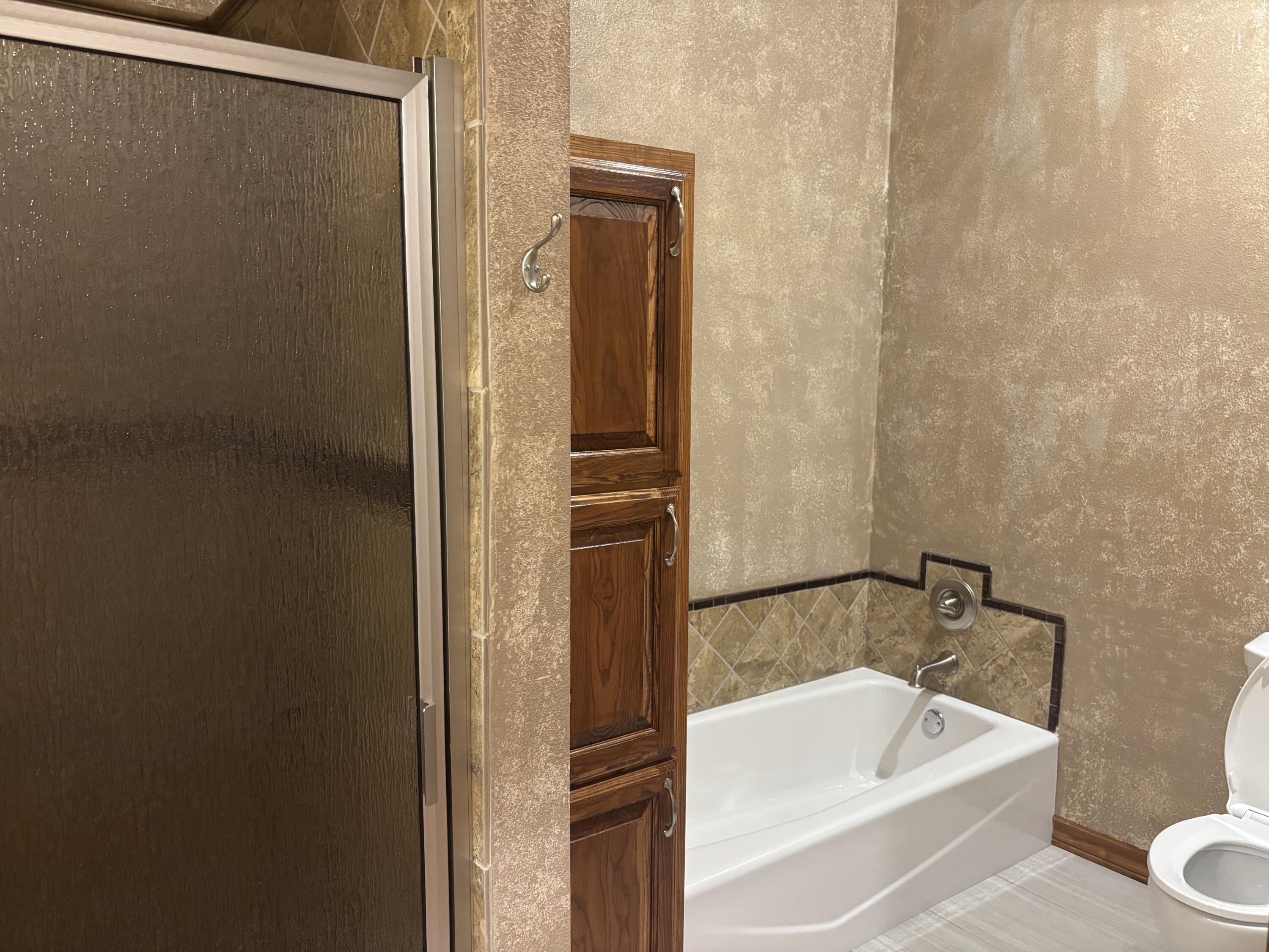 33 West Lakeshore Drive Ransom Canyon, TX 79366 - Photo 39 of 48 a bathroom with a tub and shower