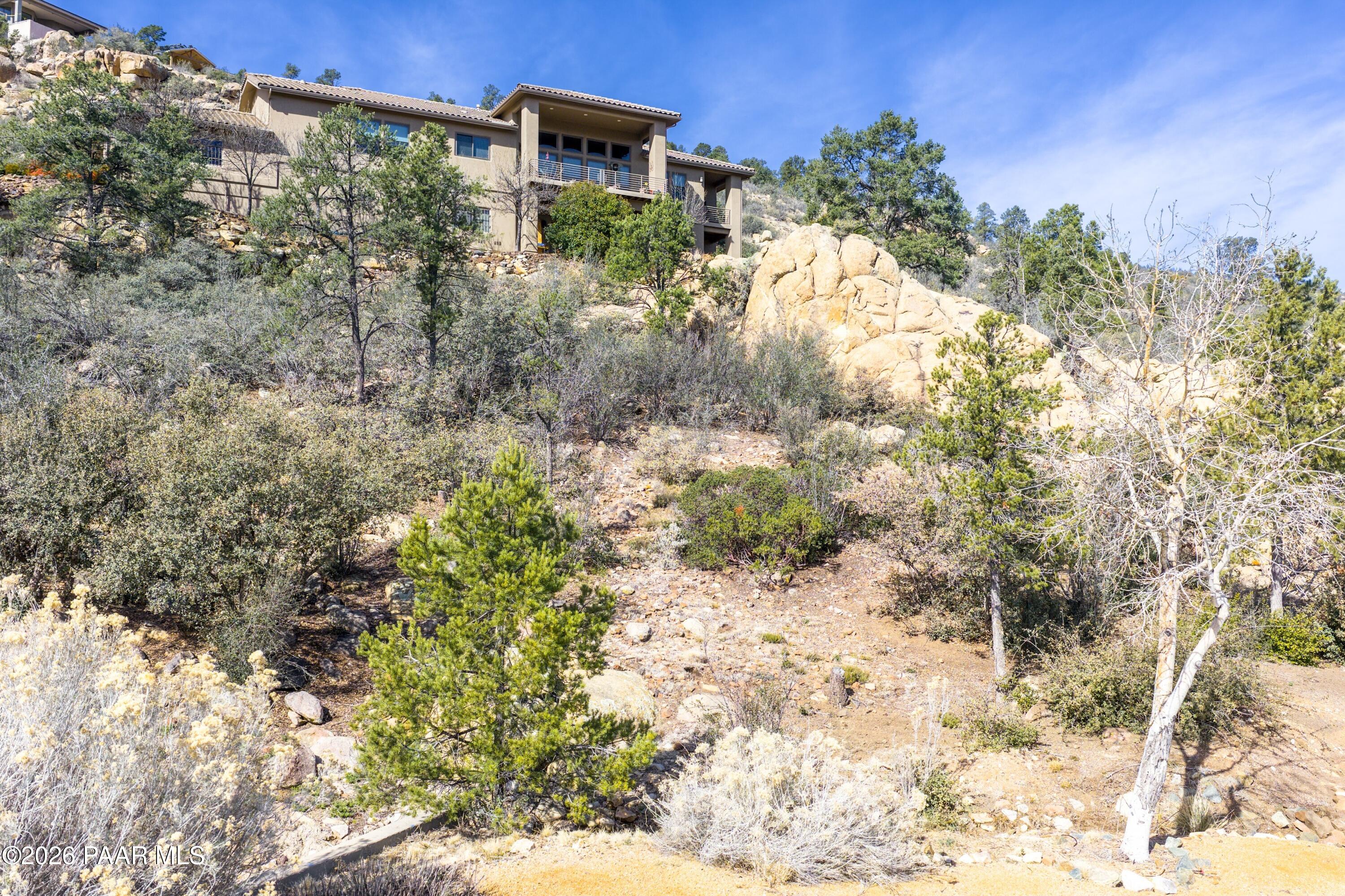 3076 La Questa Prescott, AZ 86305 - Photo 20 of 38 a backyard of a house with a yard and outdoor seating