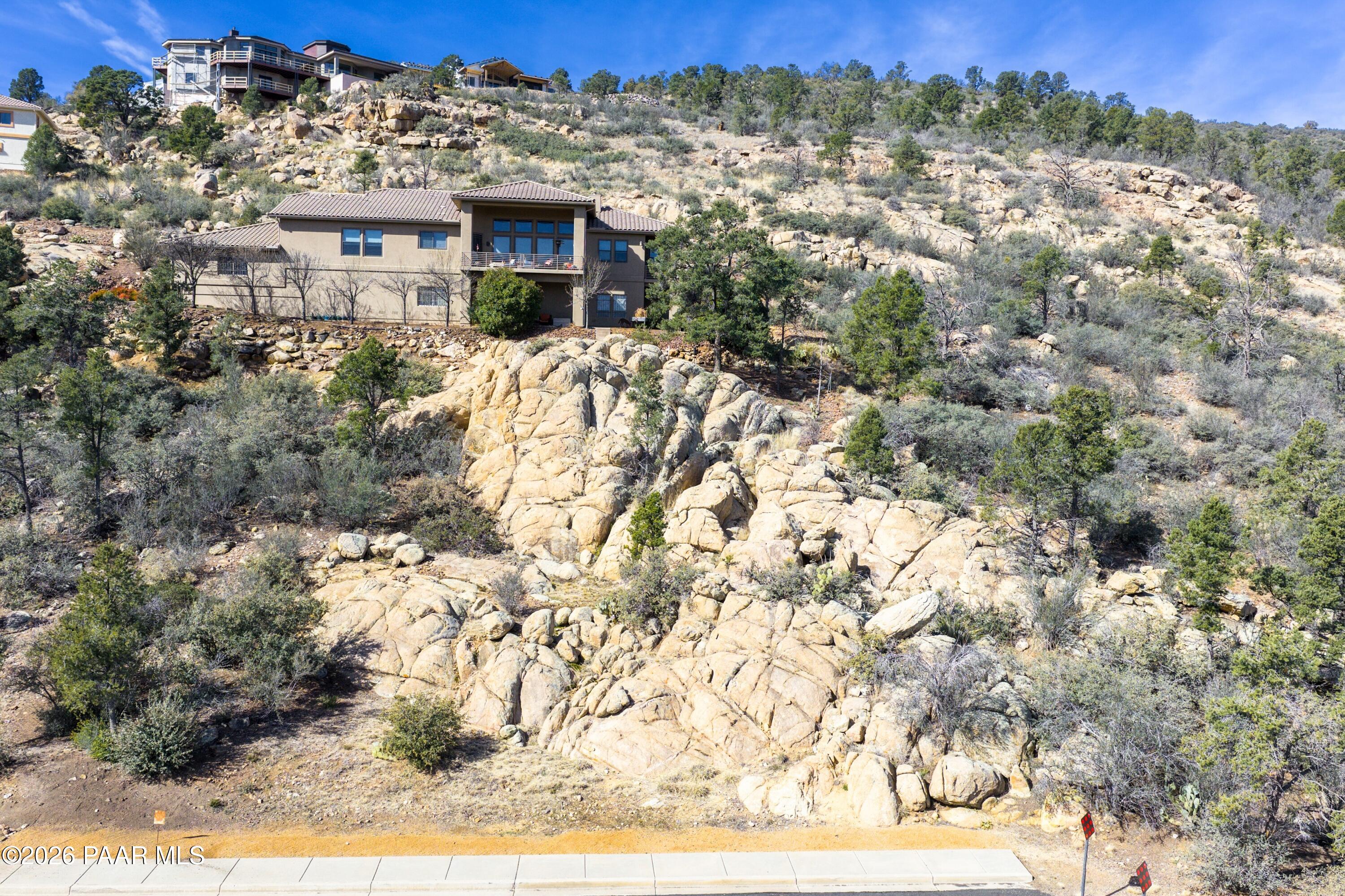 3076 La Questa Prescott, AZ 86305 - Photo 27 of 38 a view of a stone house with a yard