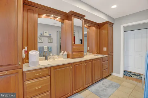 a spacious bathroom with a double vanity sink mirror and