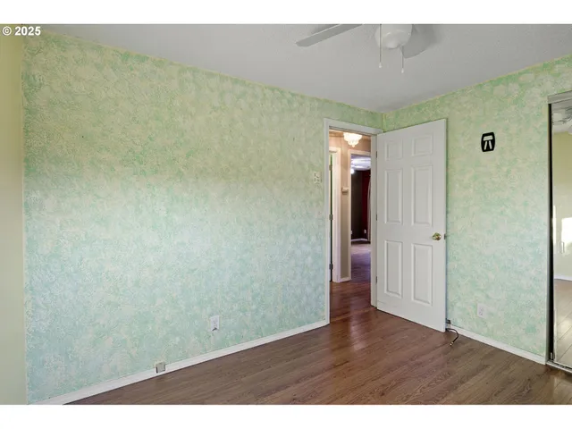 a view of a room with wooden floor
