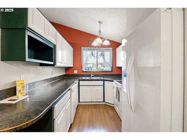 a kitchen with a sink cabinets and window