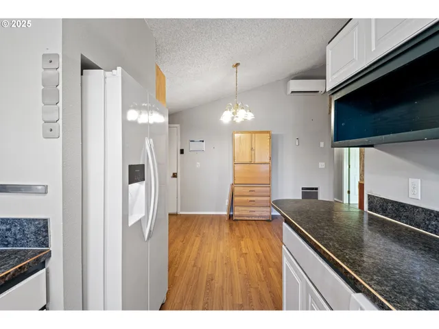 a kitchen with granite countertop a sink stainless steel appliances and cabinets