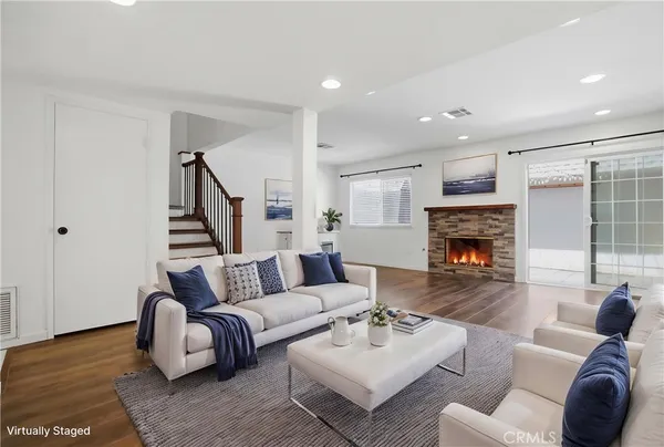 a living room with furniture and a fireplace