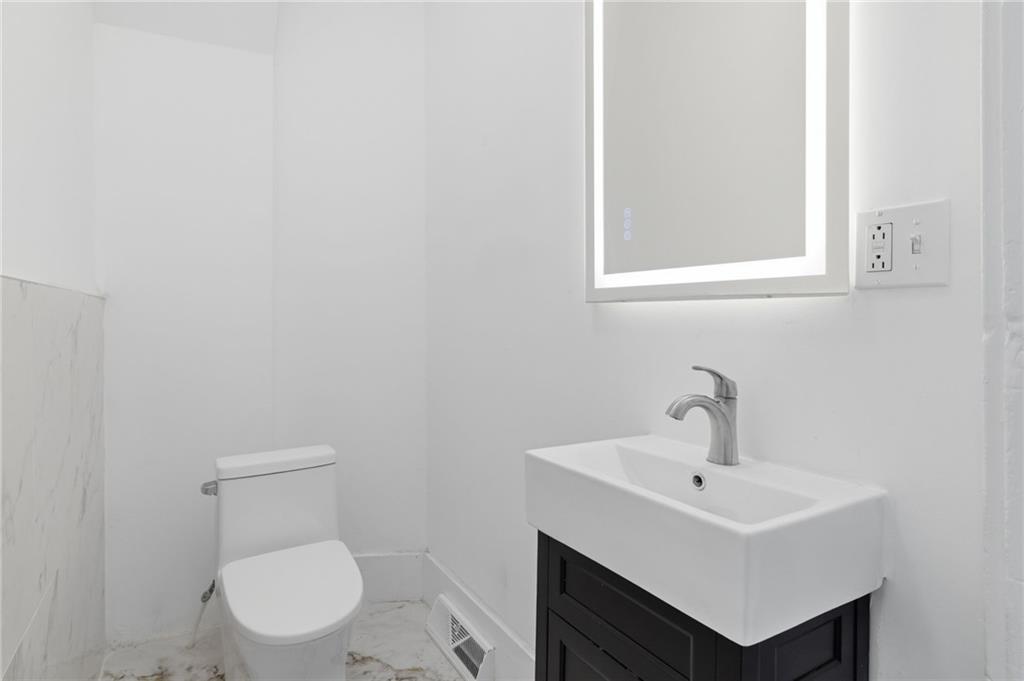 3707 Atkins Street Pittsburgh, PA 15212 - Photo 11 of 41 a bathroom with a sink a toilet and mirror