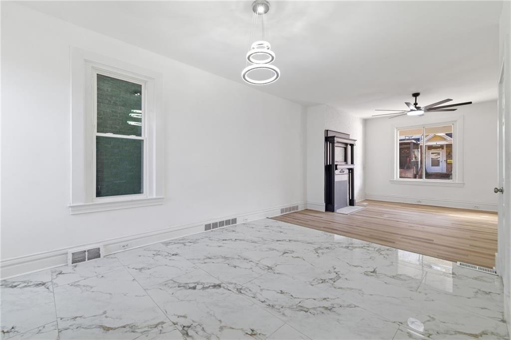 3707 Atkins Street Pittsburgh, PA 15212 - Photo 13 of 41 a view of an empty room with window and wooden floor