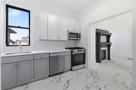 a room with a wooden cabinet and a window