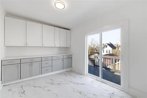 a view of staircase with wooden floor and a window