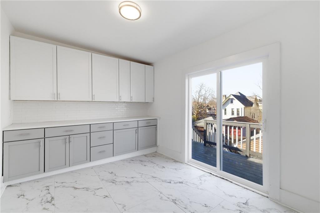 3707 Atkins Street Pittsburgh, PA 15212 - Photo 17 of 41 a room with a wooden cabinet and a window