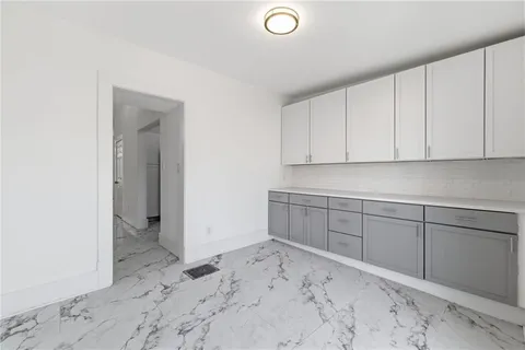 an empty room with a window and a ceiling fan