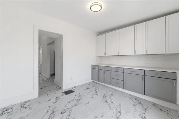 an empty room with a window and a ceiling fan