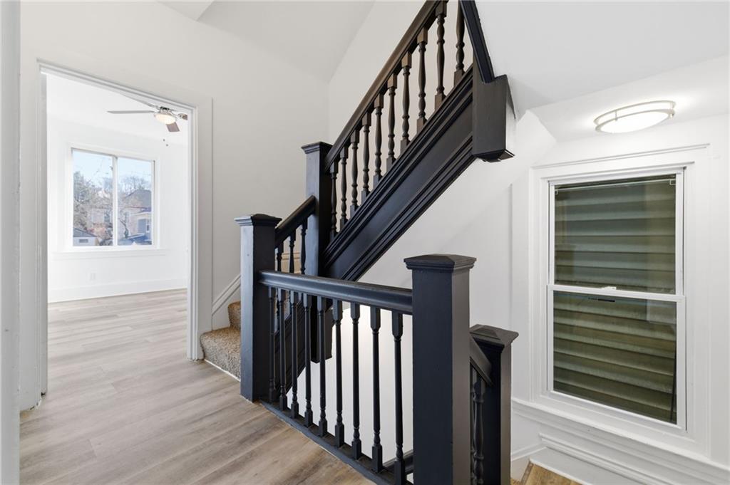 3707 Atkins Street Pittsburgh, PA 15212 - Photo 19 of 41 a view of staircase with wooden floor and a window