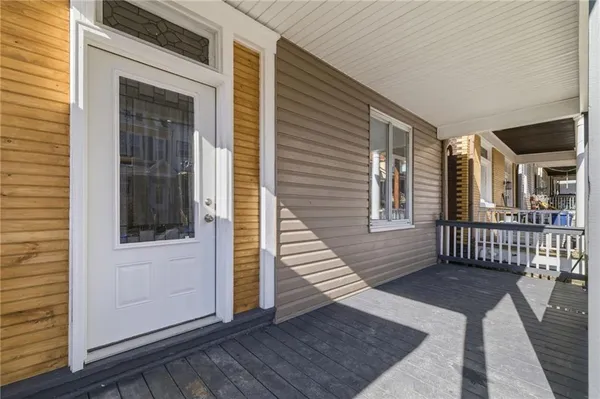 a view of empty room with wooden floor and ceiling fan