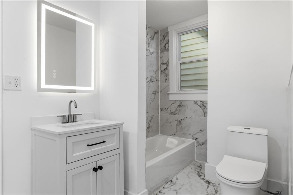 3707 Atkins Street Pittsburgh, PA 15212 - Photo 32 of 41 a bathroom with a sink a toilet and bathtub