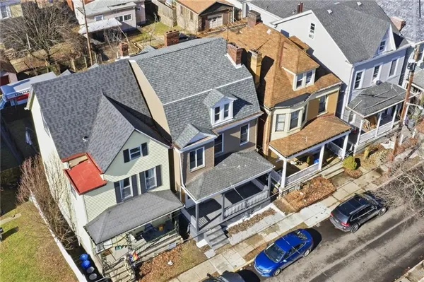 an aerial view of residential houses with outdoor space