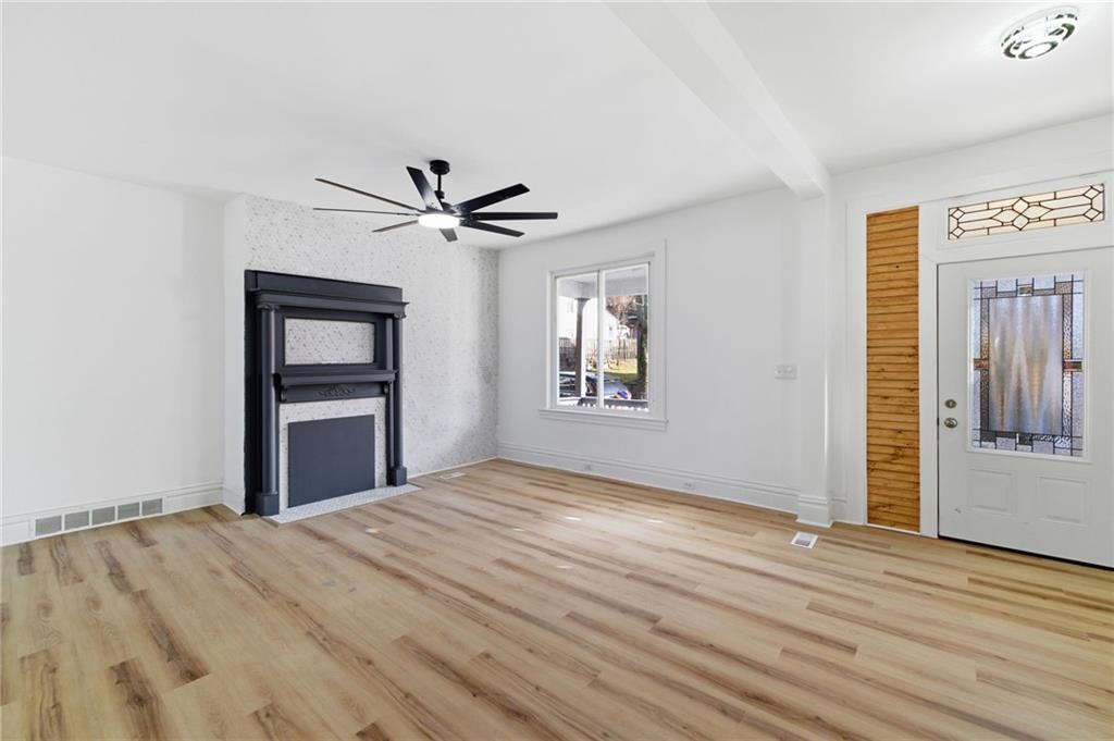 3707 Atkins Street Pittsburgh, PA 15212 - Photo 5 of 41 a view of a livingroom with a ceiling fan and wooden floor