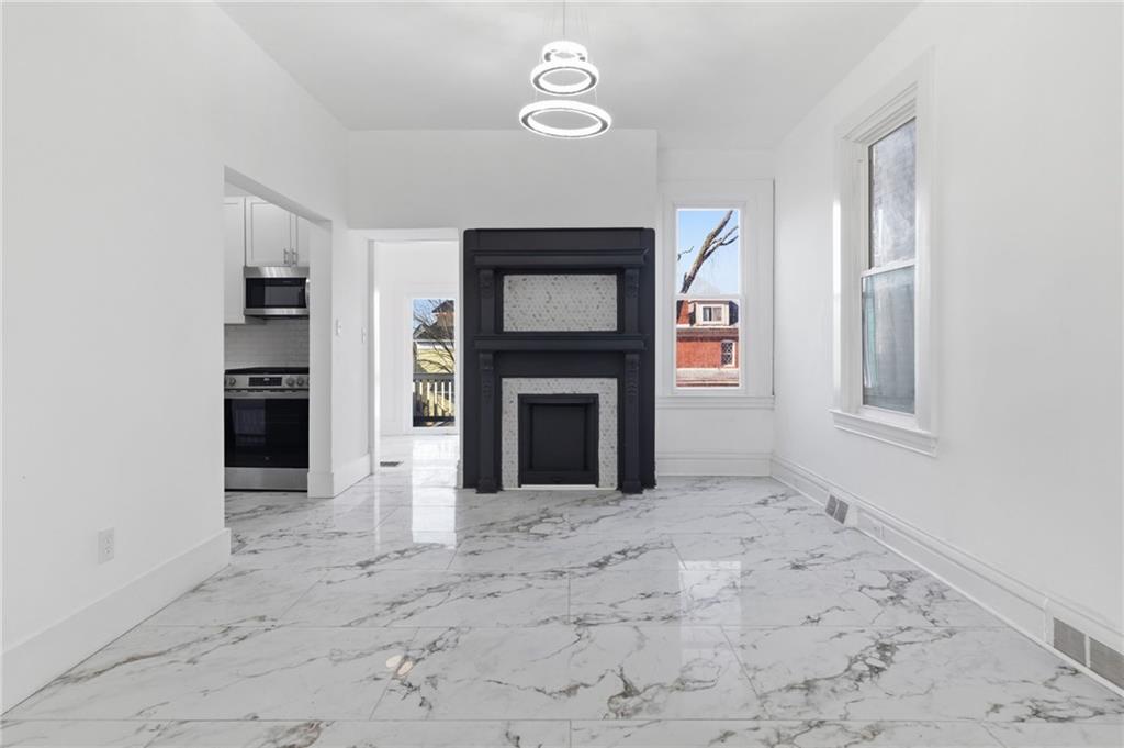 3707 Atkins Street Pittsburgh, PA 15212 - Photo 9 of 41 a view of an empty room with a fireplace