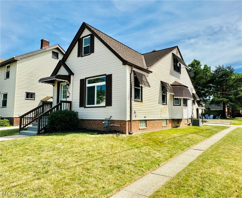 7607 Ridgefield Avenue Cleveland, OH 44129 - Photo 1 of 28 View of side of home with a lawn and central AC