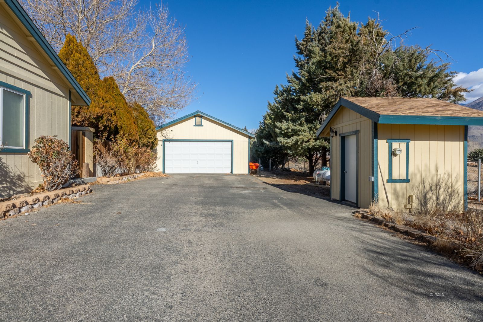 68 Ronda Lane Bishop, CA 93514 - Photo 3 of 28 a view of a house with a yard and garage