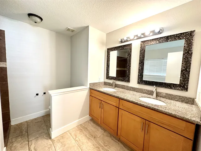 a bathroom with a granite countertop sink mirror and a