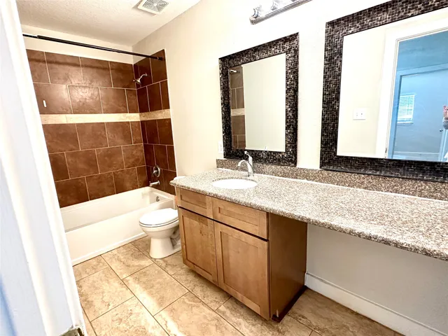 a bathroom with a double vanity sink toilet and shower
