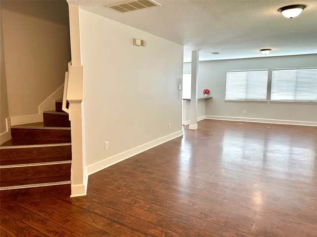 a view of an entryway with wooden floor and windows