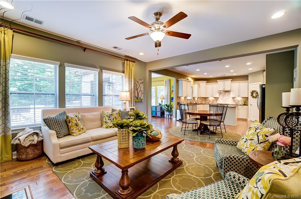 692 Old Cove Road Tega Cay, SC 29708 - Photo 12 of 44 a living room with furniture ceiling fan and a large window