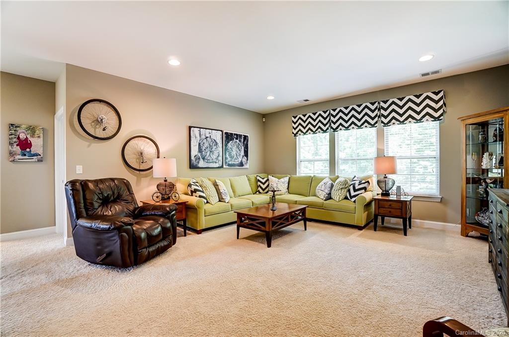 692 Old Cove Road Tega Cay, SC 29708 - Photo 22 of 44 a living room with furniture a rug and a large window