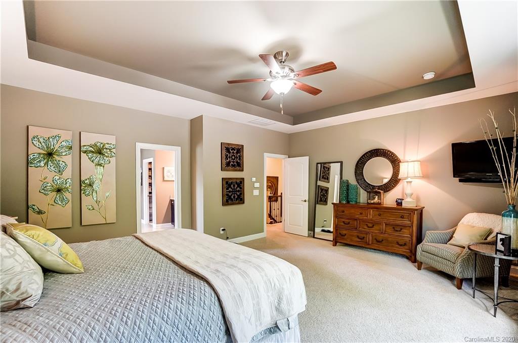 692 Old Cove Road Tega Cay, SC 29708 - Photo 24 of 44 a bedroom with a bed mirror and a large window