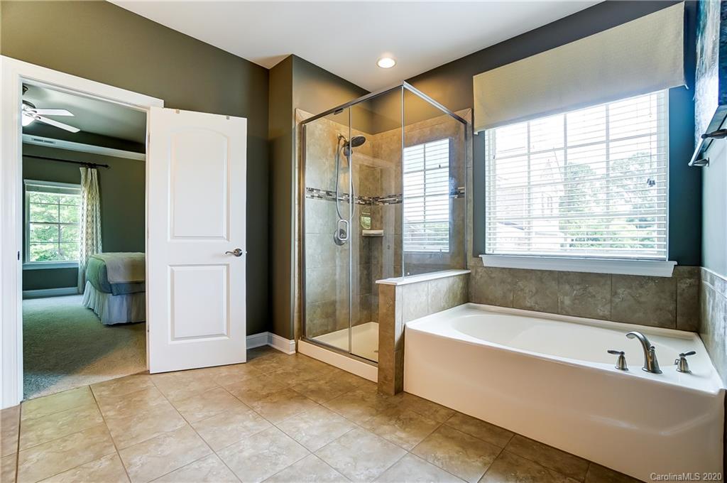 692 Old Cove Road Tega Cay, SC 29708 - Photo 26 of 44 a bathroom with a bathtub and a shower