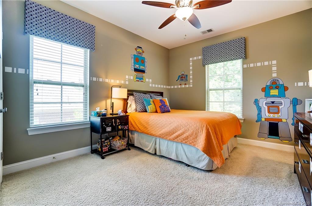 692 Old Cove Road Tega Cay, SC 29708 - Photo 29 of 44 a bed sitting in a spacious bedroom next to a window