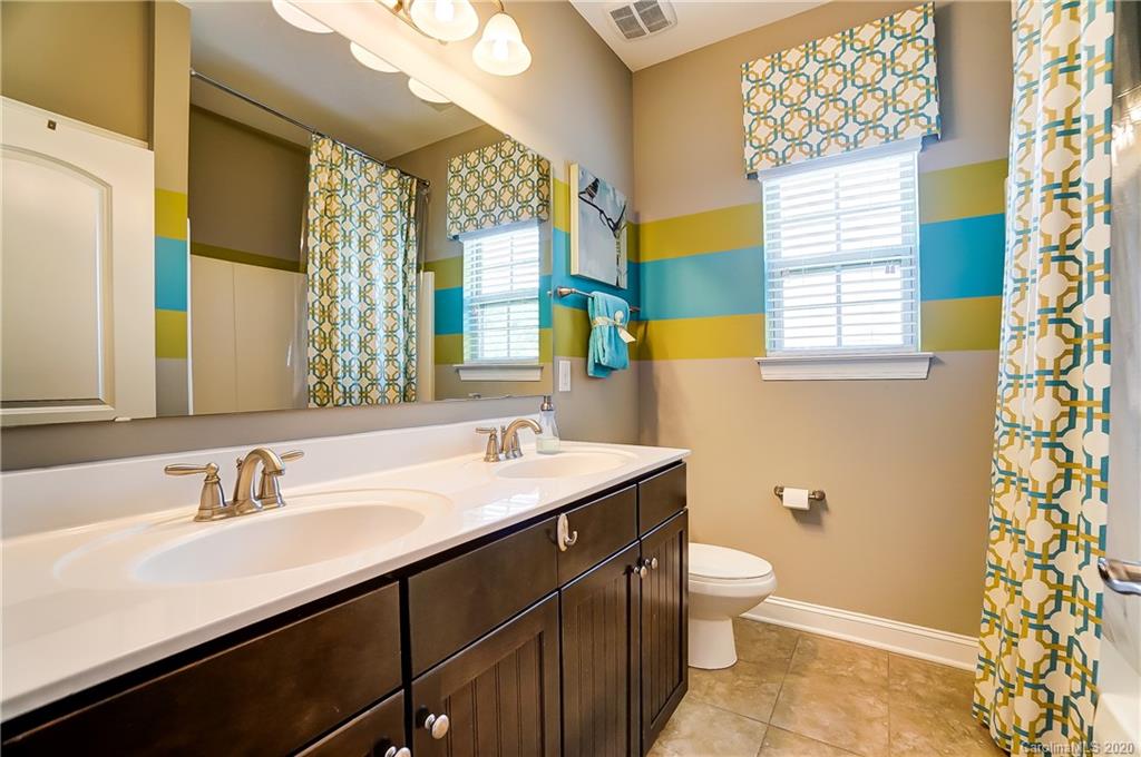692 Old Cove Road Tega Cay, SC 29708 - Photo 30 of 44 a bathroom with a sink a toilet and a large mirror