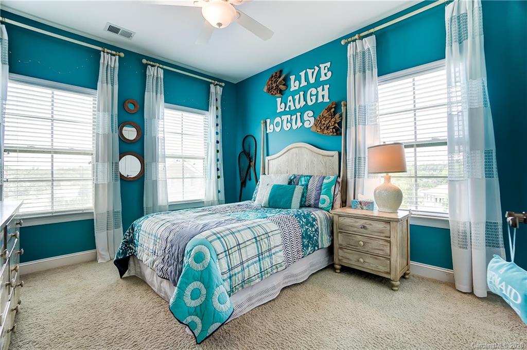 692 Old Cove Road Tega Cay, SC 29708 - Photo 31 of 44 a bedroom with a bed and a window
