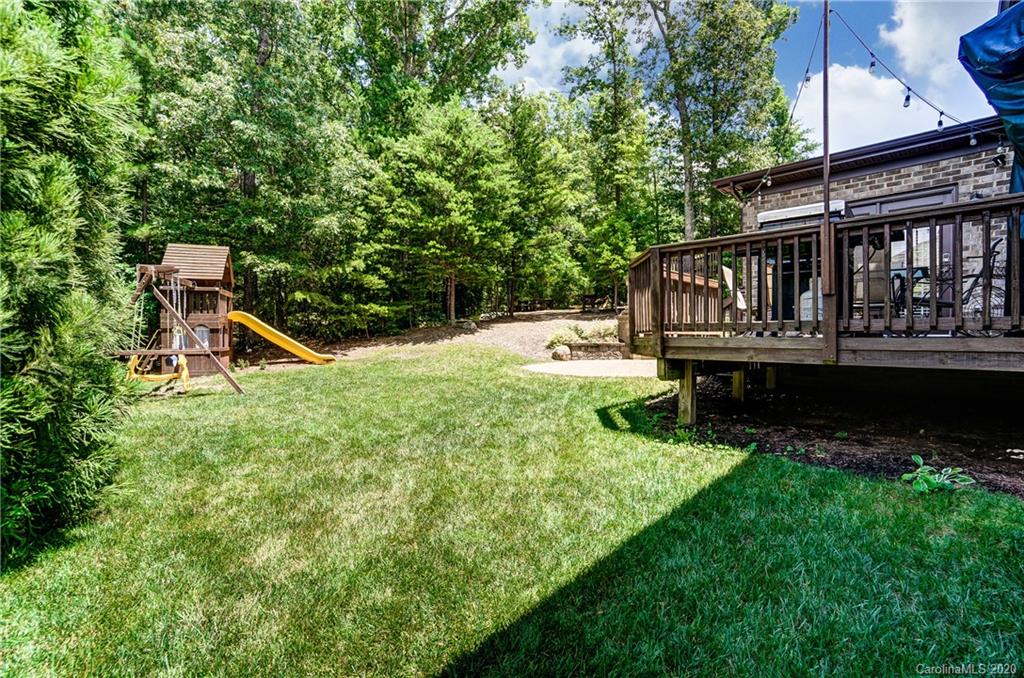 692 Old Cove Road Tega Cay, SC 29708 - Photo 39 of 44 a view of a house with wooden deck and a yard