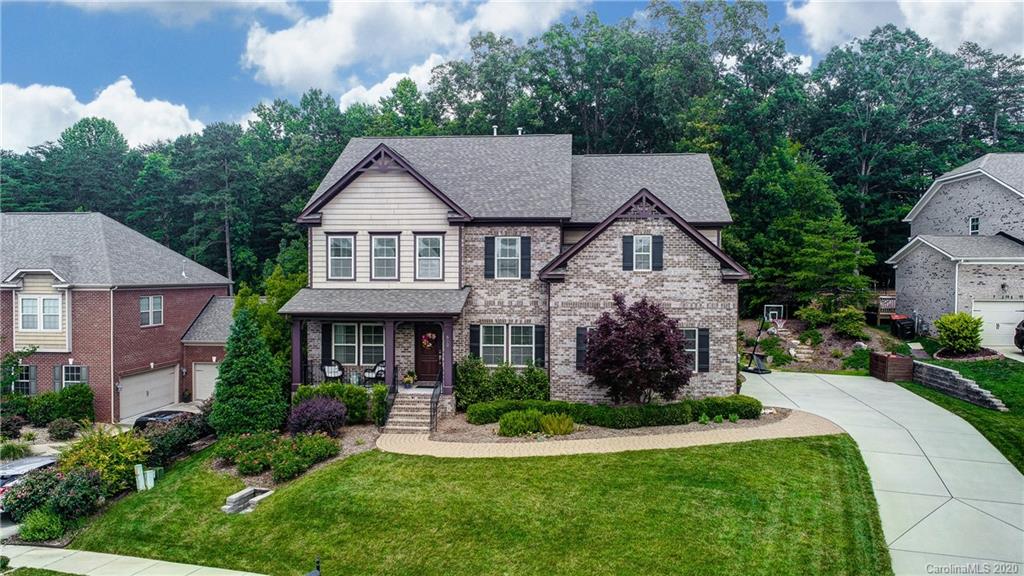 692 Old Cove Road Tega Cay, SC 29708 - Photo 41 of 44 a front view of a house with a yard and potted plants